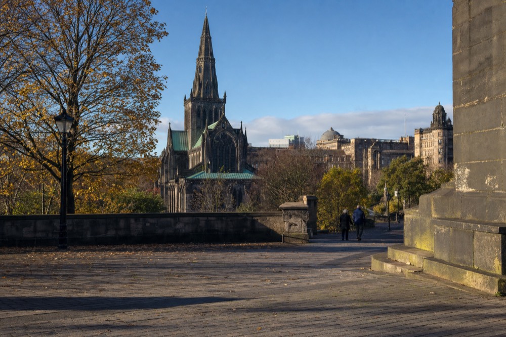 Glasgow Cathedral's gothic spire seen from Cathedral Square on a clear afternoon