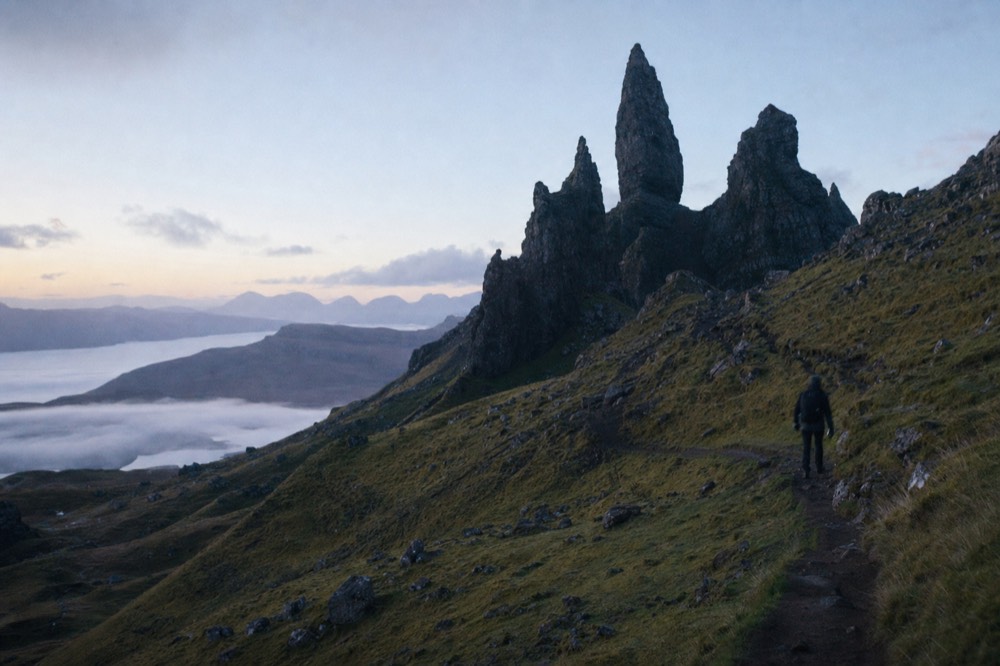 The Old Man of Storr rock pinnacle on the Isle of Skye, seen from the hiking trail below at sunrise